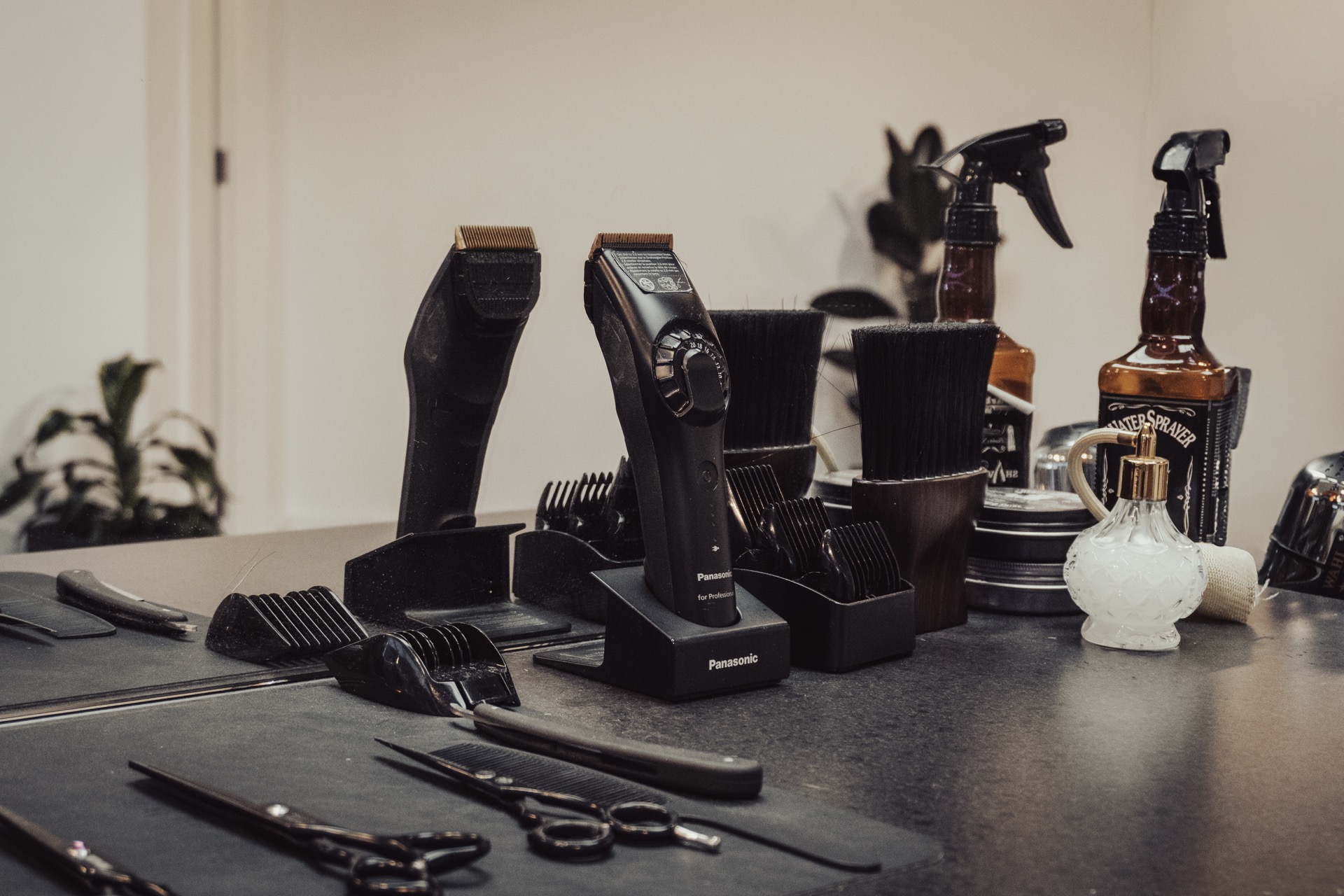 Row of skateboard decks mounted on a wall, each featuring unique artwork including a blue screaming hand, a skeleton labeled 'CREEPY,' and abstract geometric designs.